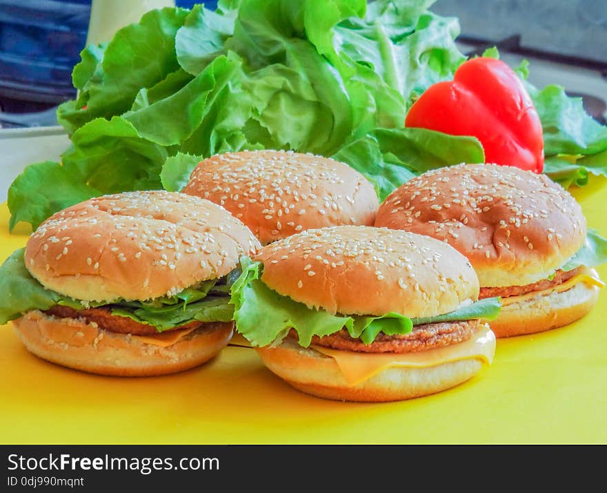 Beef hamburger with salad on ayellow plate