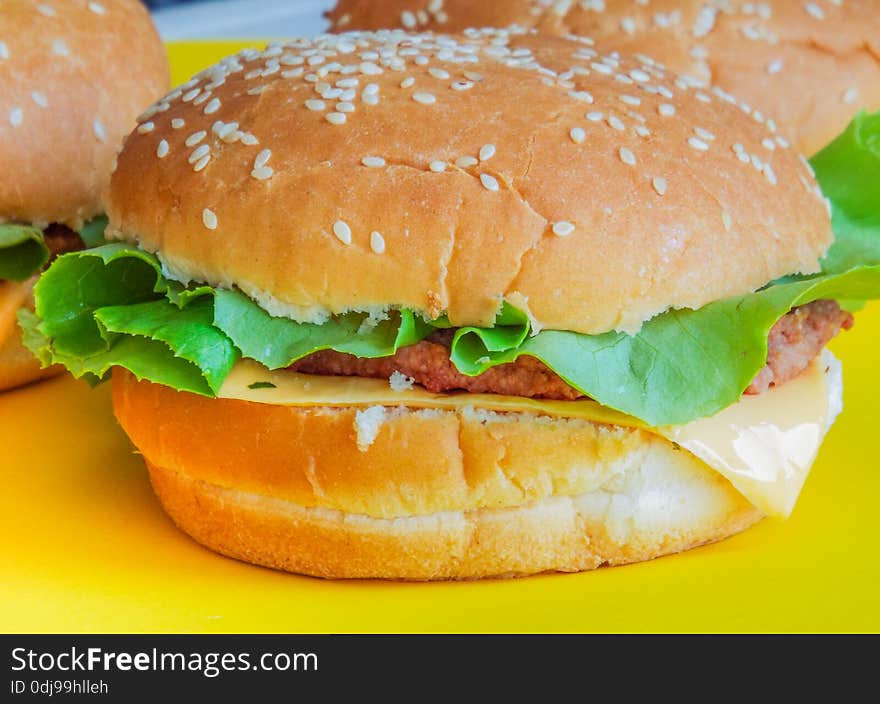 Beef Hamburger With Salad On Ayellow Plate