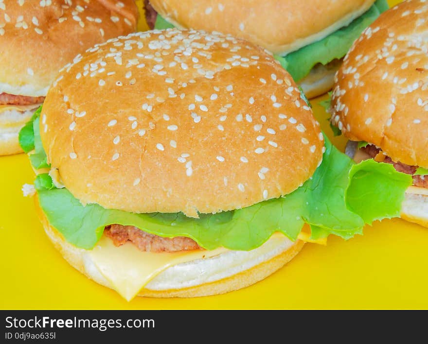 Beef hamburger with salad on ayellow plate