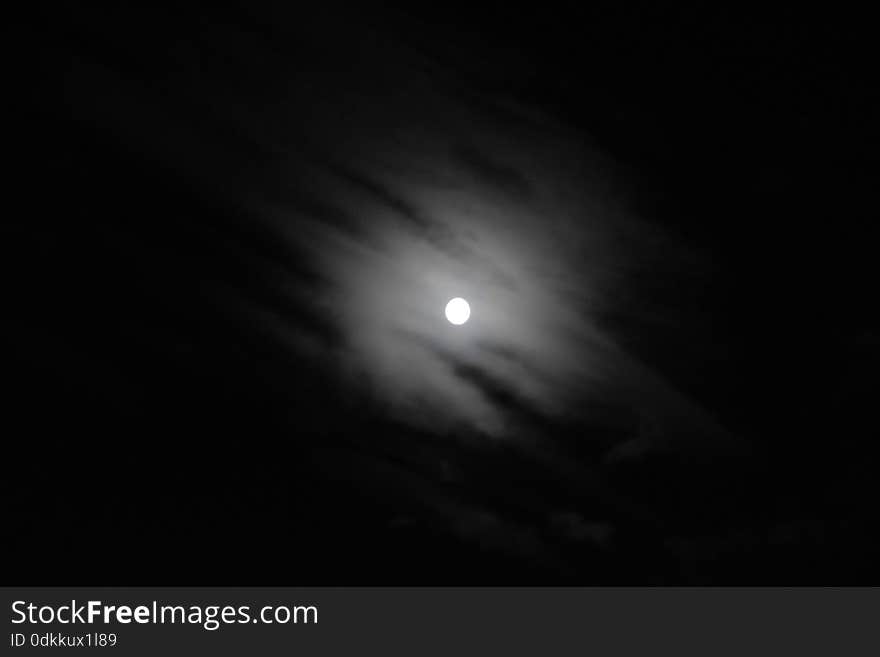 Black and white photo of the moon and clouds. Black and white photo of the moon and clouds