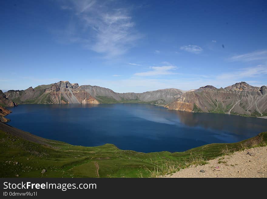 The famous view of Changbai Moutain. Tianchi lake is on the top of Changbai Mountain that formed in the crater of a huge volcano - Changbai Mountail. The water of lake is blue, it's always covered by frag, so it's lucky if you could see her beautiful view. The famous view of Changbai Moutain. Tianchi lake is on the top of Changbai Mountain that formed in the crater of a huge volcano - Changbai Mountail. The water of lake is blue, it's always covered by frag, so it's lucky if you could see her beautiful view.