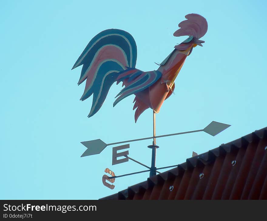 Weathervane on roof house to determine wind direction in form cock