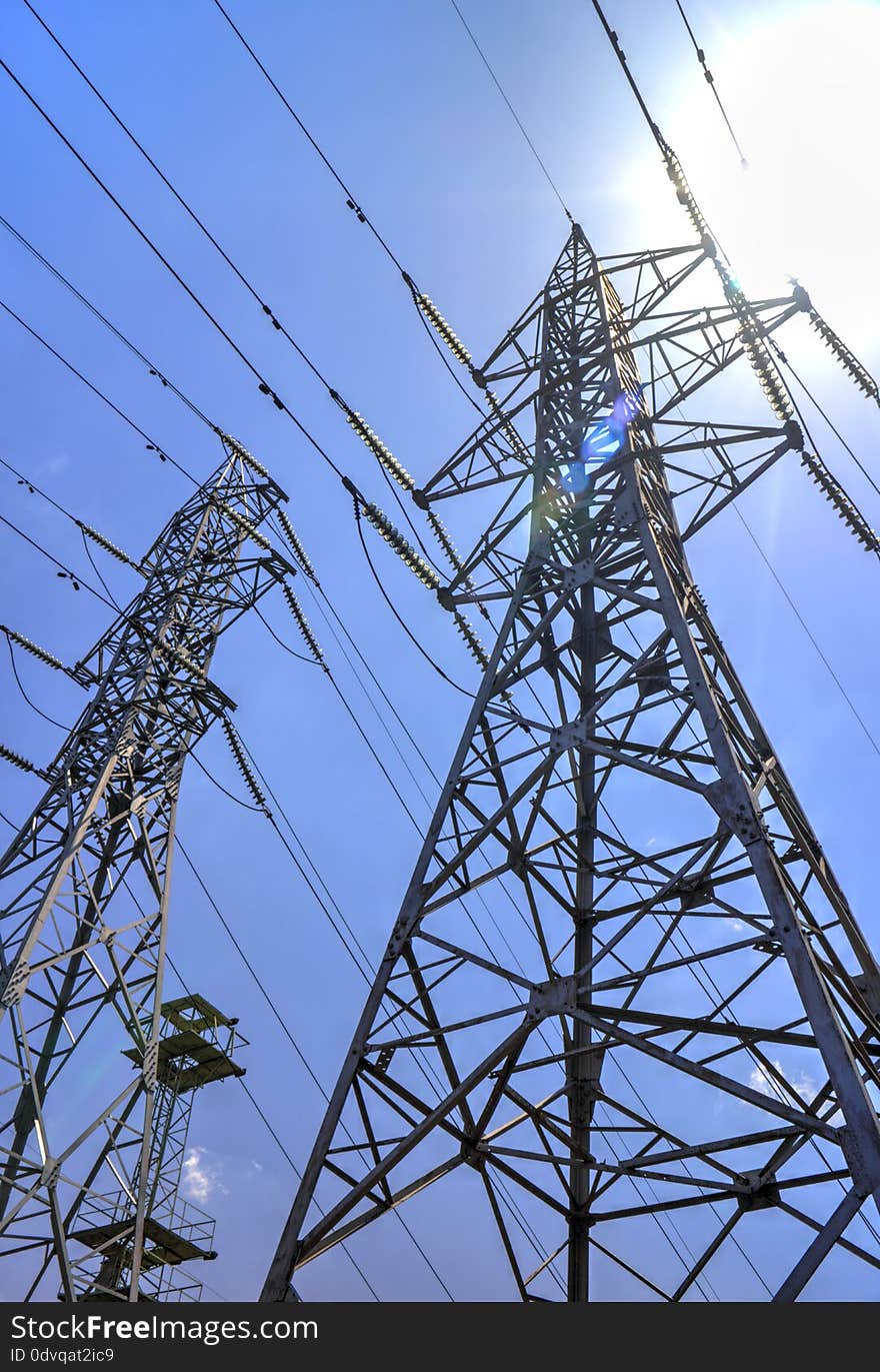 High voltage electrical overhead lines on blue sky