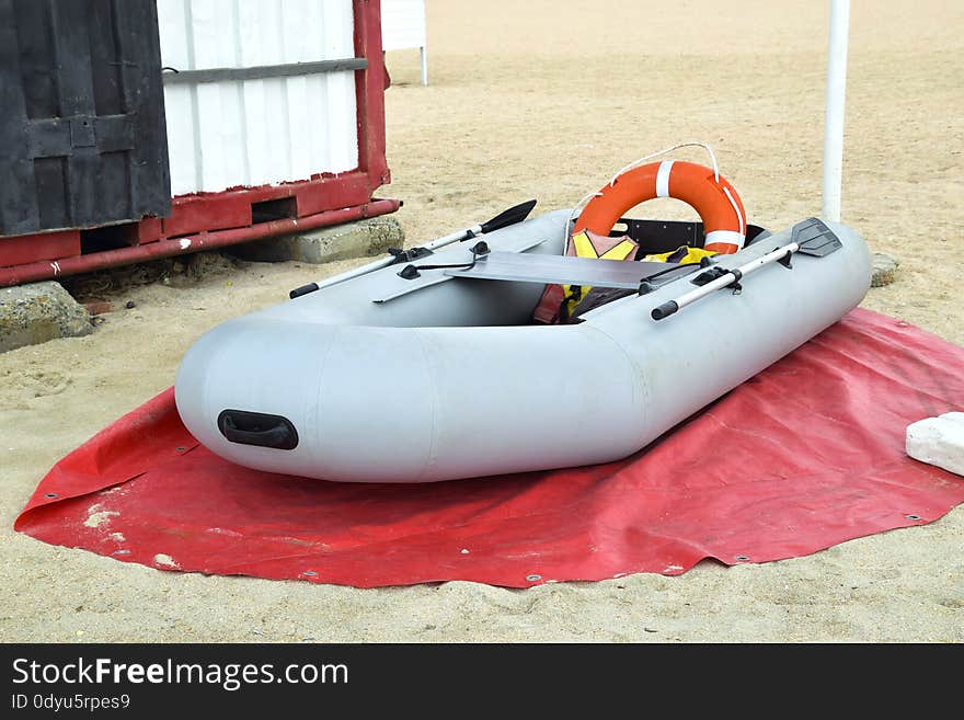 Inflatable Rescue Boat. Gray inflatable boat on the beach in the sand.