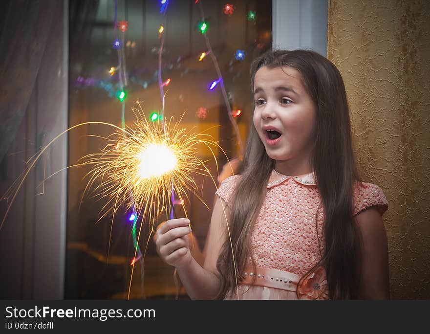 Little girl holding a sparkler