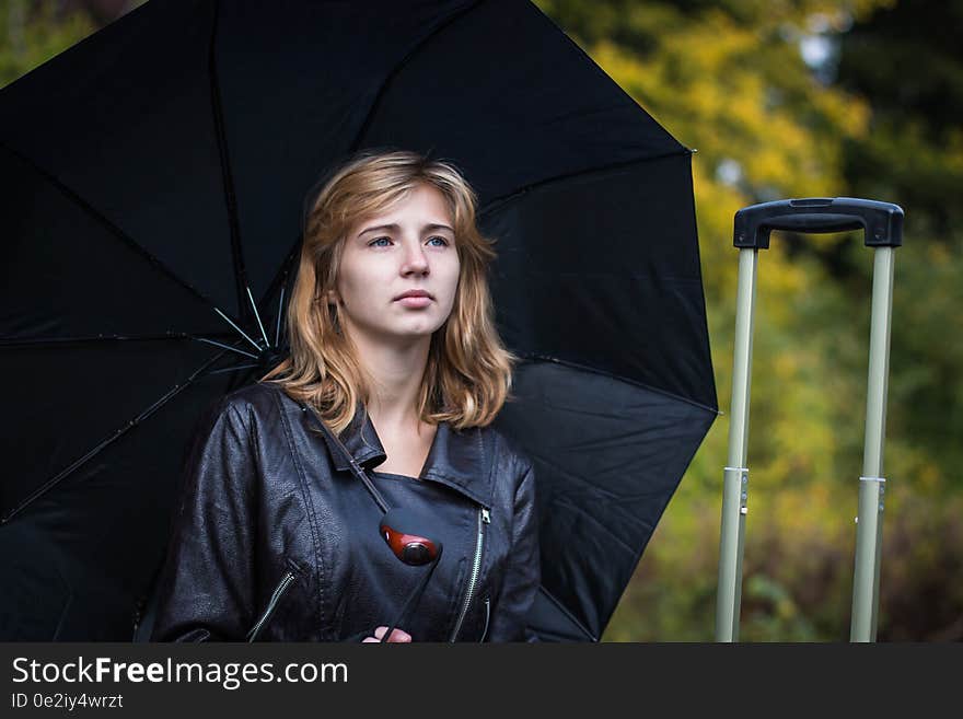 Girl, umbrella and rails in autumn day