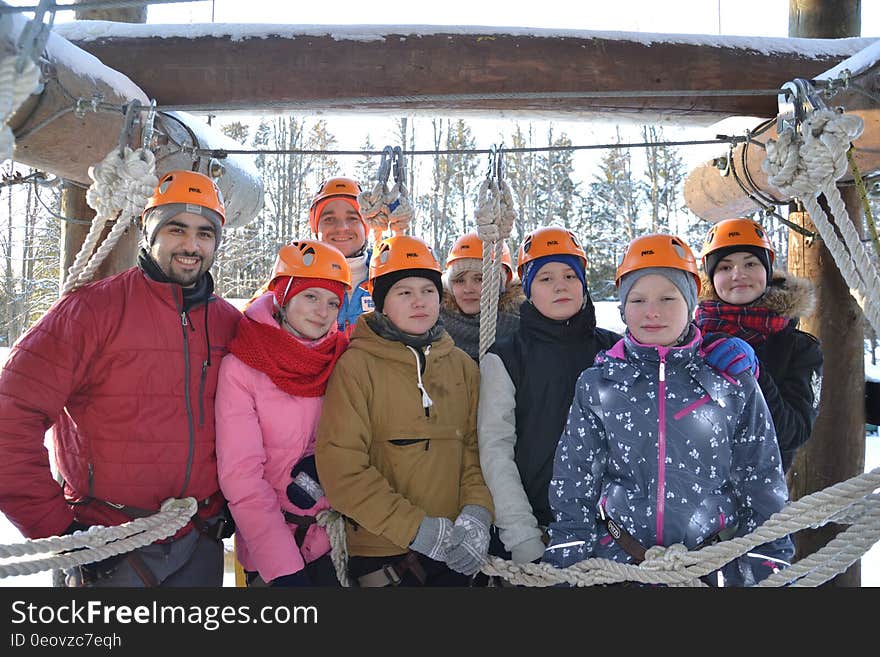 Tour group outside wearing orange hard hats. Tour group outside wearing orange hard hats.