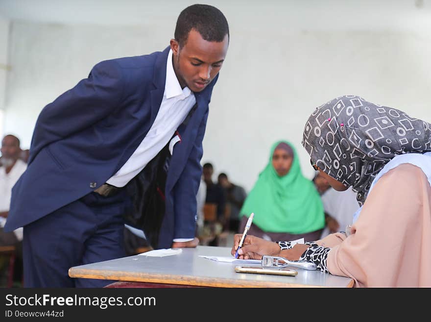 An electoral official verifies the identity of a delegate during the electoral process to choose members of the Lower House of the of the Somali federal Parliament in Garowe, Somalia on November 23, 2016. AMISOM Photo. An electoral official verifies the identity of a delegate during the electoral process to choose members of the Lower House of the of the Somali federal Parliament in Garowe, Somalia on November 23, 2016. AMISOM Photo