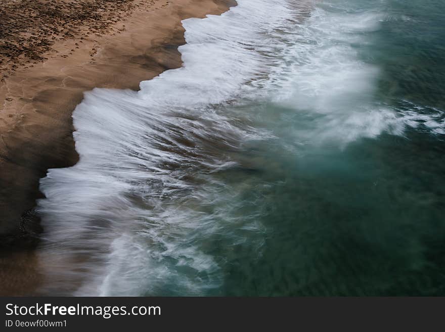 Waves splashing on the sandy shores of the ocean. Waves splashing on the sandy shores of the ocean.