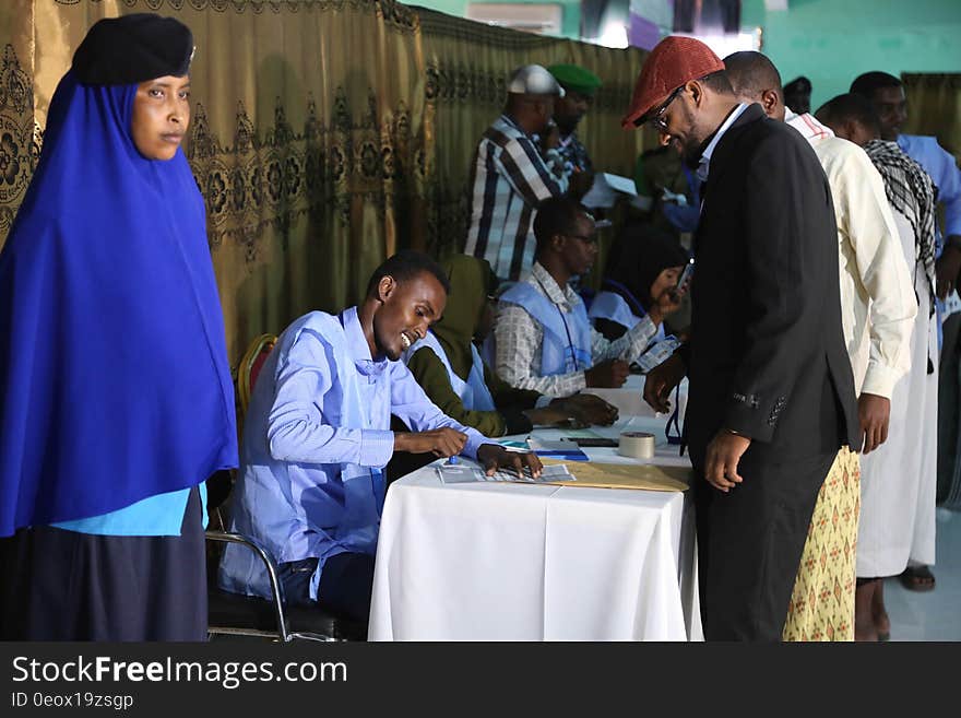 Electoral official stamps on the ballot paper during the electoral process to choose members of the Lower House of the Federal parliament in Cadaado, Somalia on November 28, 2016. AMISOM Photo. Electoral official stamps on the ballot paper during the electoral process to choose members of the Lower House of the Federal parliament in Cadaado, Somalia on November 28, 2016. AMISOM Photo