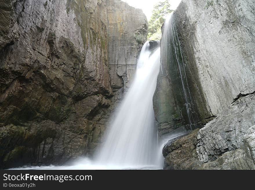 Waterfalls over rocky ridge down steep stone ravine. Waterfalls over rocky ridge down steep stone ravine.