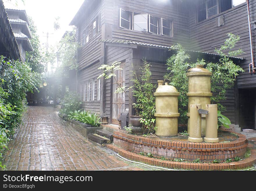 Wet brick walkway outside wooden home and garden on rainy day. Wet brick walkway outside wooden home and garden on rainy day.