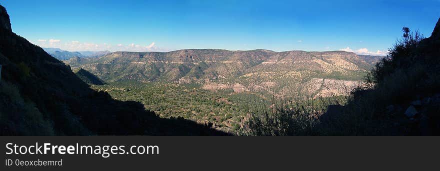 View of the canyon above Fossil Creek from Fossil Creek Road &#x28;FR 708&#x29; in 2006. The flume &#x28;now removed&#x29; that once fed water from the diversion dam at the springs to the Irving power plant is visible running along the length of the canyon. This section of road is currently &#x28;2016&#x29; closed due to safety issues caused by rock falls along the cliff above the road. Fossil Creek is one of only two National Wild &amp; Scenic rivers in Arizona and is fed by springs coming from the cliffs of the Mogollon Rim. Over 30 million gallons of water are discharged each day at a constant 70&deg;F. The high mineral content leaves travertine dams and deposits, giving rise to fossil-like features. In 2005, Arizona Public Service &#x28;APS&#x29; decommissioned the Fossil Creek Dam and Flume, restoring full flows to Fossil Creek. The diversion dam at Fossil Springs was partially removed, allowing the creek to flow freely. The flume that once carried water to the power plant was disassembled. The Irving power plant and other buildings around the site were removed. Traces of history remain visible at the Irving site and along the Flume Trail in the form of old building foundations, rock work along the flume&#x27;s maintenance road, and concrete pilings that once supported the flume. Photo by Deborah Lee Soltesz, November 26, 2006. Credit: Coconino National Forest, U.S. Forest Service. Learn more about Fossil Creek Wild and Scenic River on the Coconino National Forest. This is a stitched panorama. Some portions of the edges &#x28;mainly the sky&#x29; were edited to fill in areas that were not photographed. View of the canyon above Fossil Creek from Fossil Creek Road &#x28;FR 708&#x29; in 2006. The flume &#x28;now removed&#x29; that once fed water from the diversion dam at the springs to the Irving power plant is visible running along the length of the canyon. This section of road is currently &#x28;2016&#x29; closed due to safety issues caused by rock falls along the cliff above the road. Fossil Creek is one of only two National Wild &amp; Scenic rivers in Arizona and is fed by springs coming from the cliffs of the Mogollon Rim. Over 30 million gallons of water are discharged each day at a constant 70&deg;F. The high mineral content leaves travertine dams and deposits, giving rise to fossil-like features. In 2005, Arizona Public Service &#x28;APS&#x29; decommissioned the Fossil Creek Dam and Flume, restoring full flows to Fossil Creek. The diversion dam at Fossil Springs was partially removed, allowing the creek to flow freely. The flume that once carried water to the power plant was disassembled. The Irving power plant and other buildings around the site were removed. Traces of history remain visible at the Irving site and along the Flume Trail in the form of old building foundations, rock work along the flume&#x27;s maintenance road, and concrete pilings that once supported the flume. Photo by Deborah Lee Soltesz, November 26, 2006. Credit: Coconino National Forest, U.S. Forest Service. Learn more about Fossil Creek Wild and Scenic River on the Coconino National Forest. This is a stitched panorama. Some portions of the edges &#x28;mainly the sky&#x29; were edited to fill in areas that were not photographed.