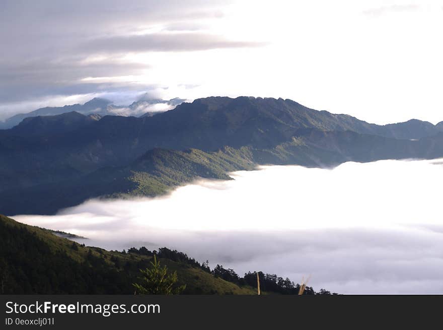 Mist in valley along mountain peaks. Mist in valley along mountain peaks.