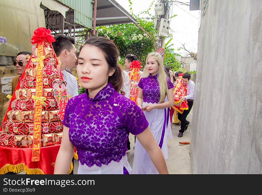 Asian tradition with people carrying tables of gold boxes.