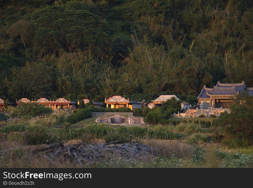 A traditional Asian village by the woods and the hills.