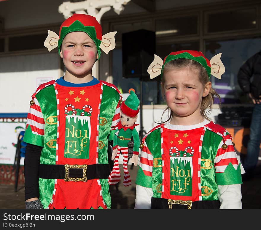 Boy and girl standing outdoors dressed in elf costumes. Boy and girl standing outdoors dressed in elf costumes.