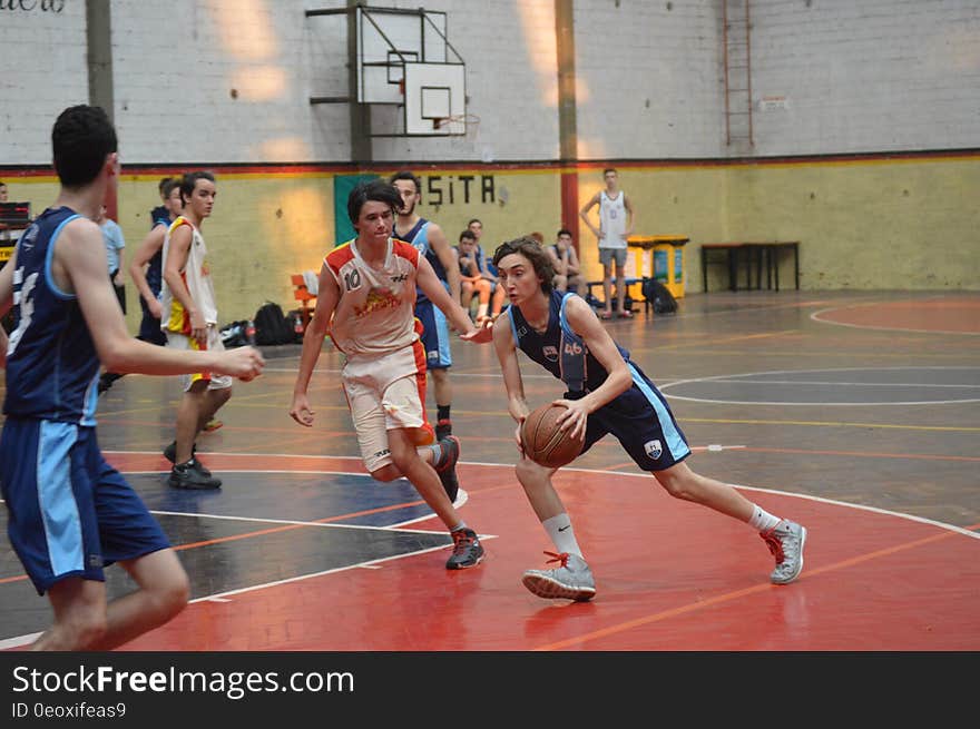 Athletes during a basketball game on indoor court. Athletes during a basketball game on indoor court.