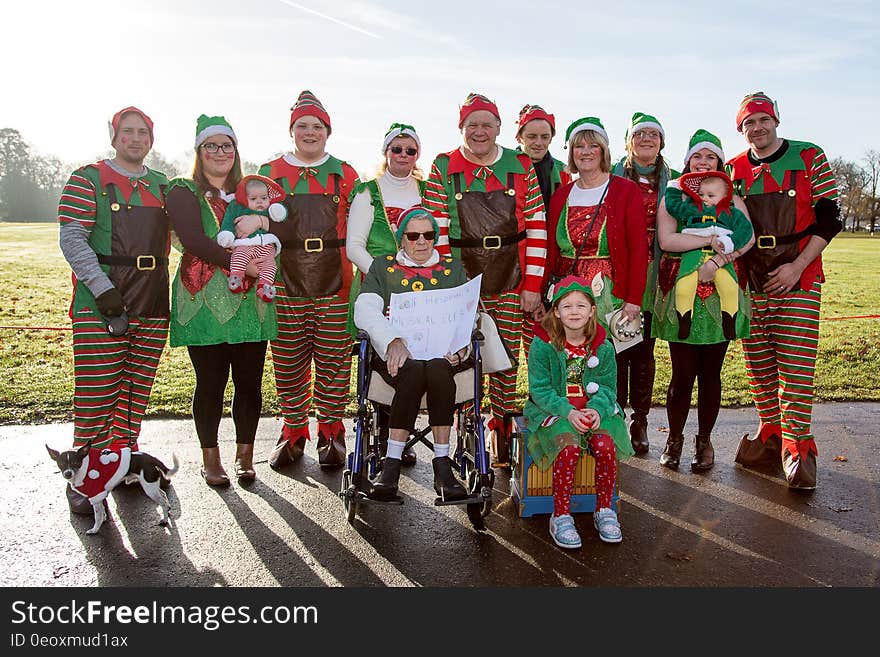 Group of adult men and women with babies and children dressed in elf costumes. Group of adult men and women with babies and children dressed in elf costumes.