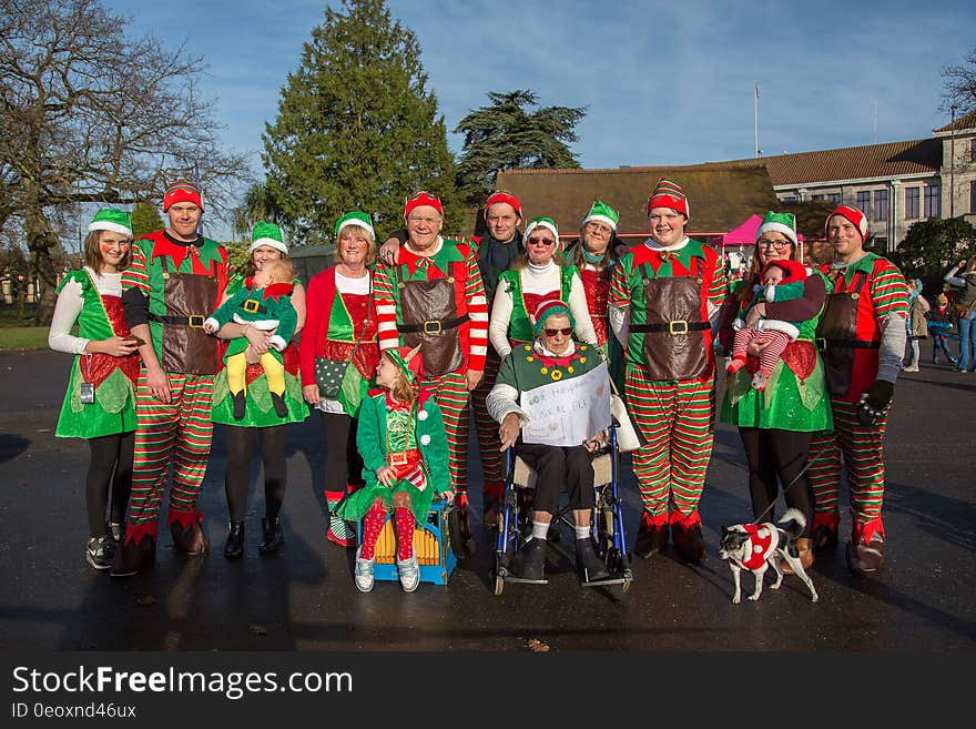 Group of people outdoors dressed in elf costumes on sunny day. Group of people outdoors dressed in elf costumes on sunny day.