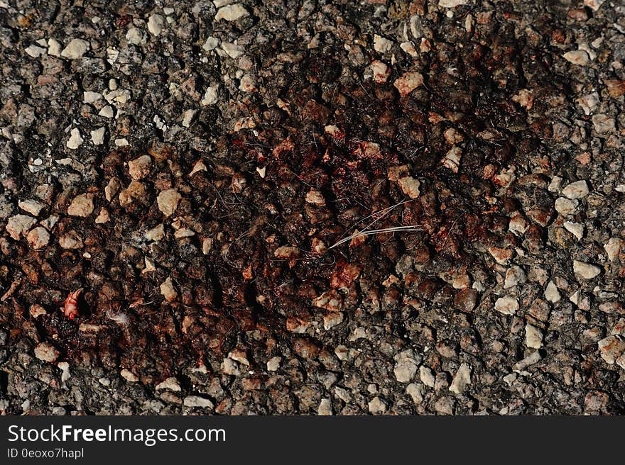 Close up of dark red stain on pebbles. Close up of dark red stain on pebbles.