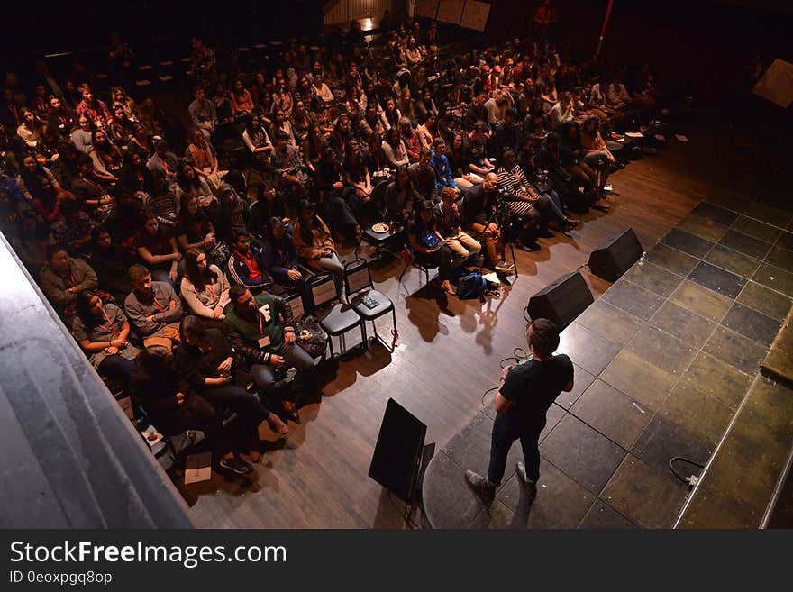 Speaker on stage with participants at TEDxYouth 2016 conference. Speaker on stage with participants at TEDxYouth 2016 conference.