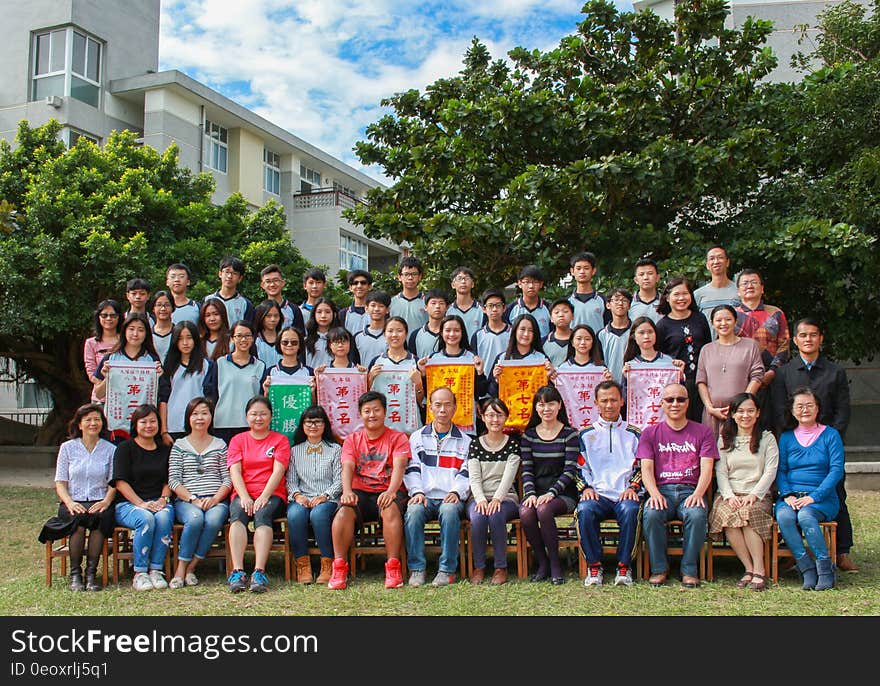 Outdoor photo of group of men and women in sunny courtyard. Outdoor photo of group of men and women in sunny courtyard.