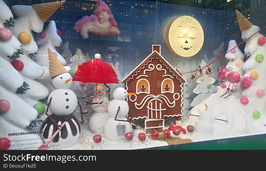 Gingerbread house and snow men in wintry Christmas display. Gingerbread house and snow men in wintry Christmas display.