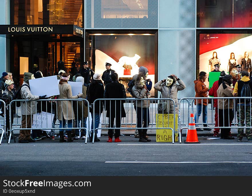 Protesters outside Louis Vuitton shop on city streets. Protesters outside Louis Vuitton shop on city streets.