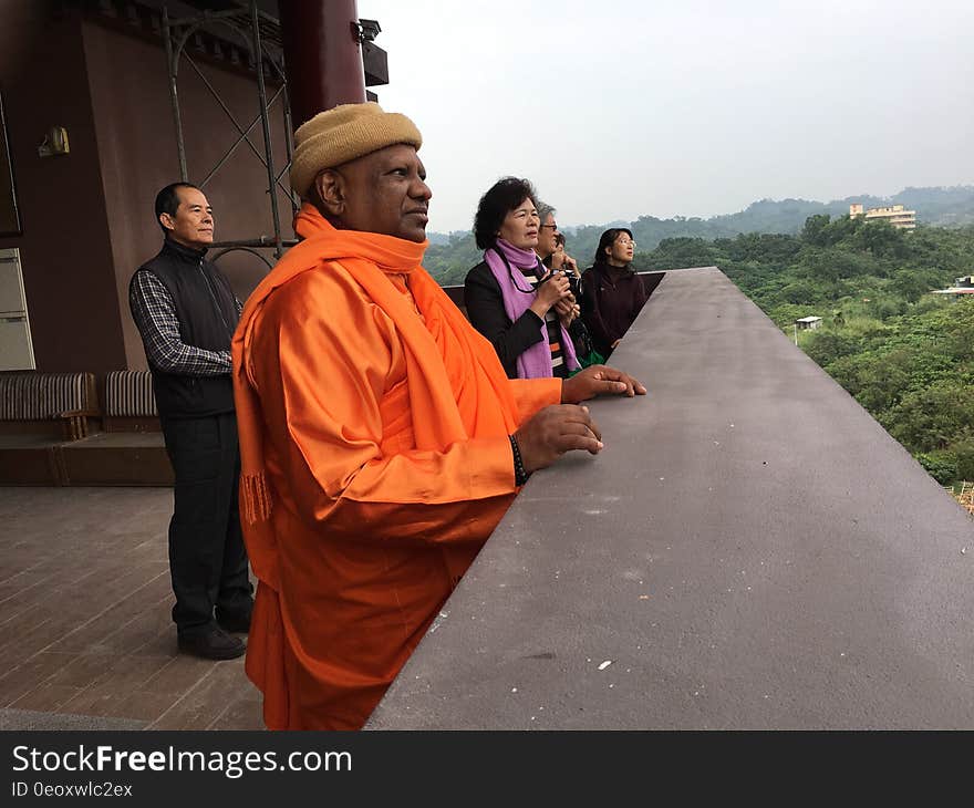 Tourists standing outdoors on balcony overlook or observation deck at rural countryside. Tourists standing outdoors on balcony overlook or observation deck at rural countryside.