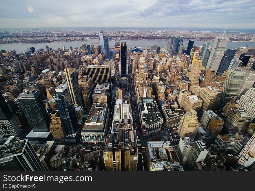 Aerial view over modern waterfront skyline in large city with blue skies. Aerial view over modern waterfront skyline in large city with blue skies.