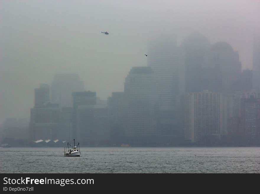 Foggy waterfront of Manhattan, New York City, NY with boat and helicopter. Foggy waterfront of Manhattan, New York City, NY with boat and helicopter.