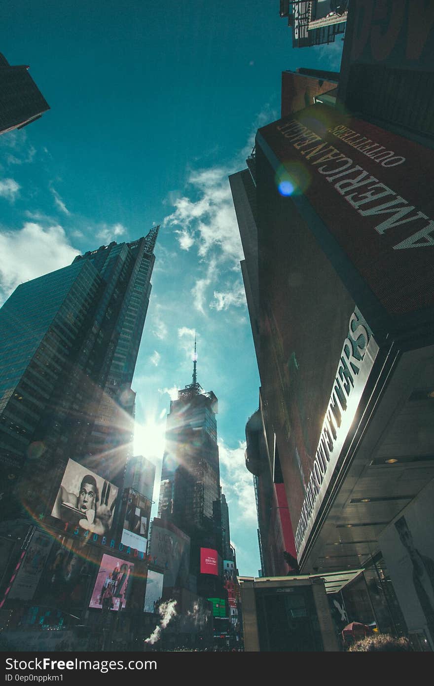 Skyline of Manhattan, New York against blue skies.