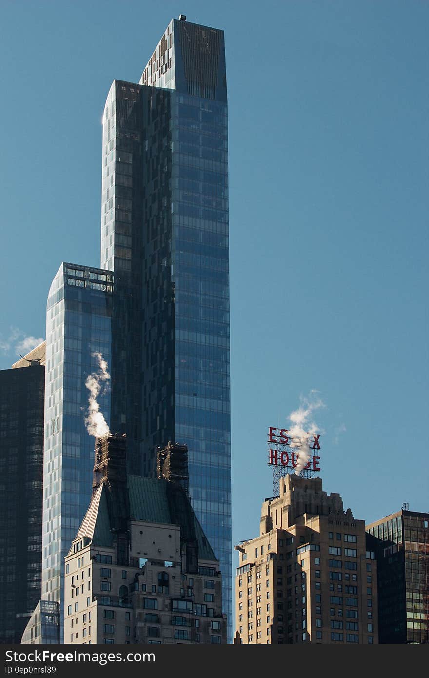 Modern skyscraper against blue skies in modern skyline on sunny day.