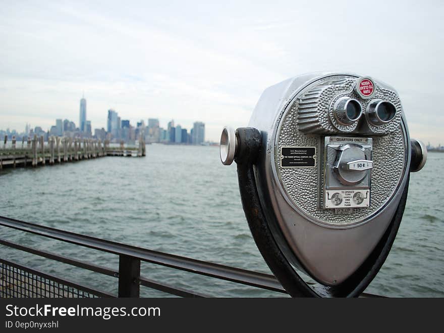 A tourist viewfinder overlooks a harbour.