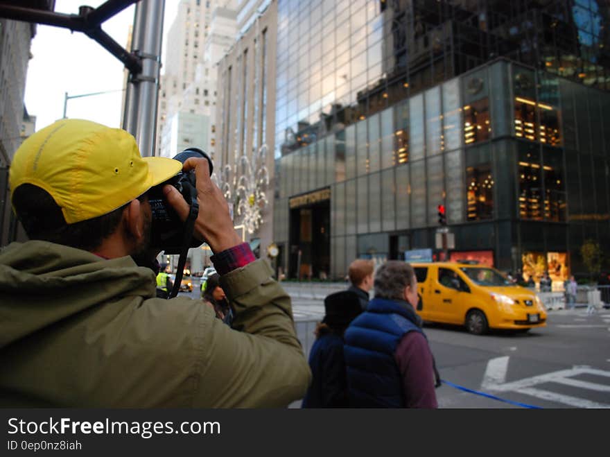 A tourist takes photos of a building. A tourist takes photos of a building.