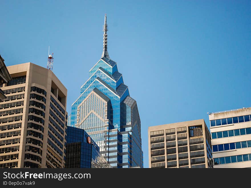 Facade of modern building roof tops against blue skies on sunny day. Facade of modern building roof tops against blue skies on sunny day.