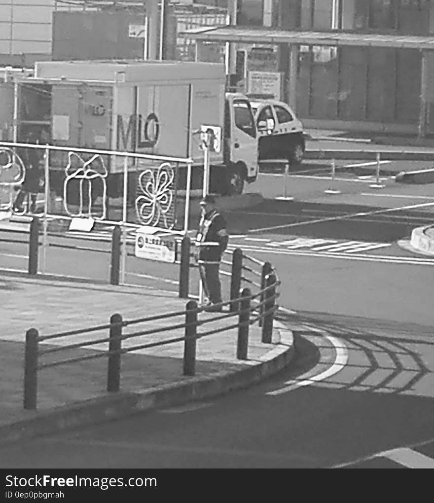 Man standing on corner of city street with holiday decorations in black and white. Man standing on corner of city street with holiday decorations in black and white.