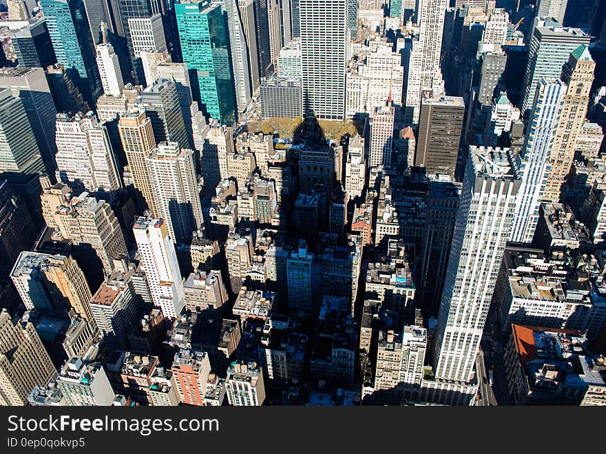 Shadow of skyscraper over rooftops of Manhattan, New York on sunny day. Shadow of skyscraper over rooftops of Manhattan, New York on sunny day.