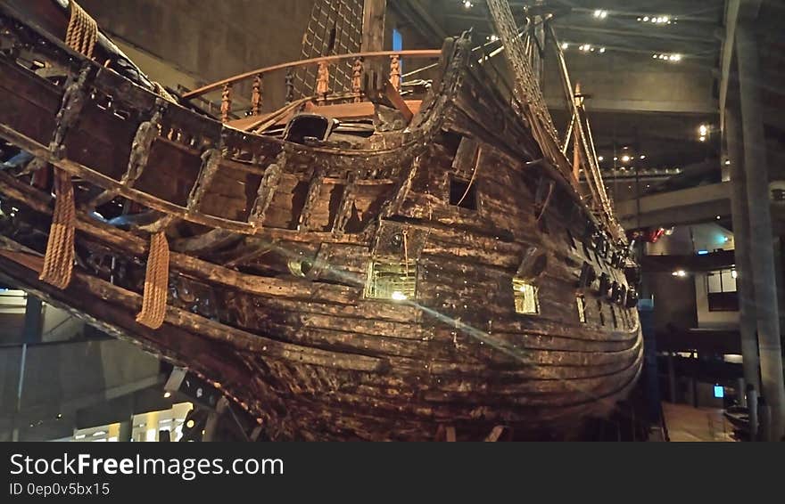 Bow and hull of vintage wooden sailing ship inside museum halls. Bow and hull of vintage wooden sailing ship inside museum halls.