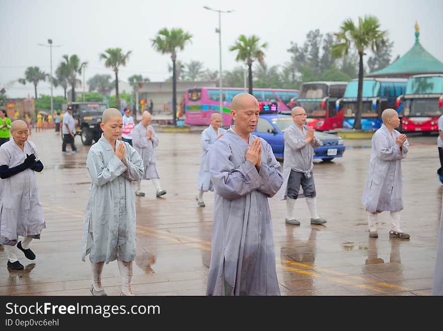 Monks in grey robes in outdoor procession in rain. Monks in grey robes in outdoor procession in rain.