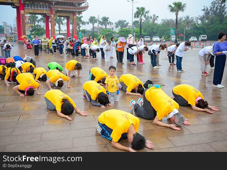 Two groups of people doing yoga outdoor in the Far East. Two groups of people doing yoga outdoor in the Far East.