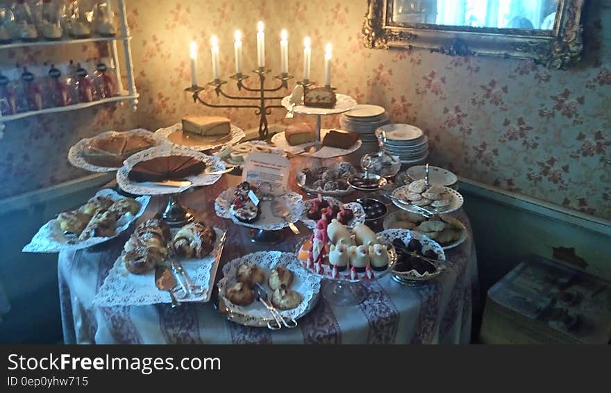 Table full of sweet deserts illuminated with Menorah. Table full of sweet deserts illuminated with Menorah.