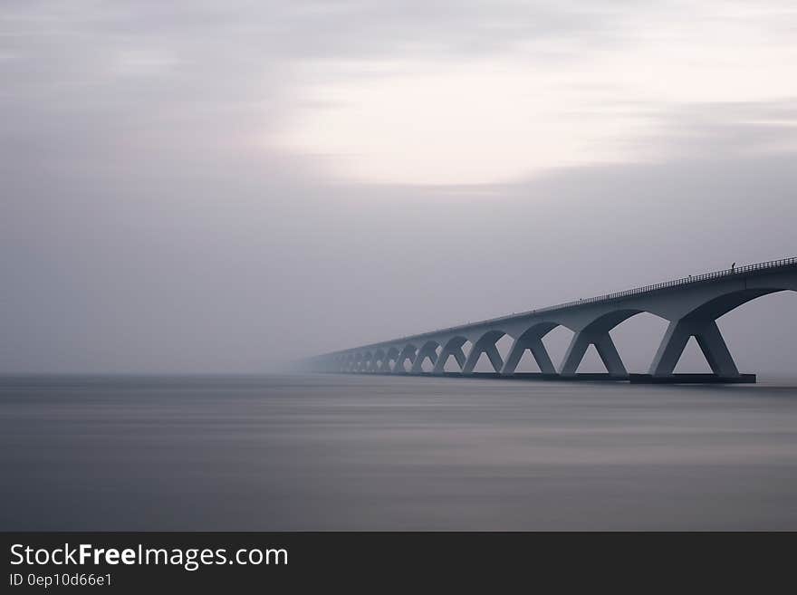 Modern bridge over waterway in fog or mist. Modern bridge over waterway in fog or mist.