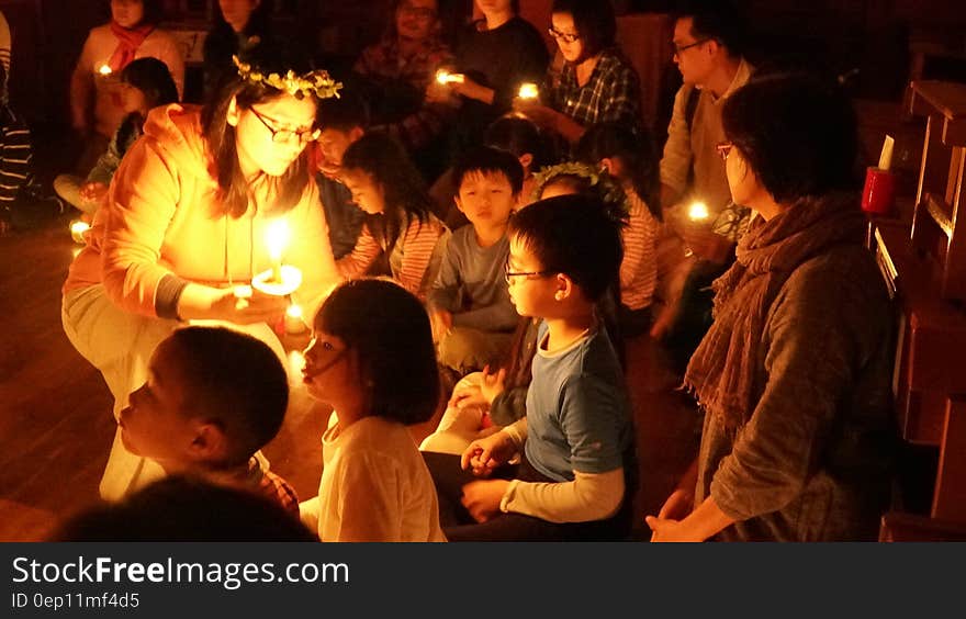 Children in candle lighting ceremony indoors. Children in candle lighting ceremony indoors.