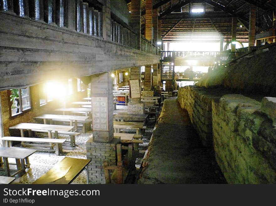 Interior of empty rustic restaurant with long wooden tables and benches. Interior of empty rustic restaurant with long wooden tables and benches.