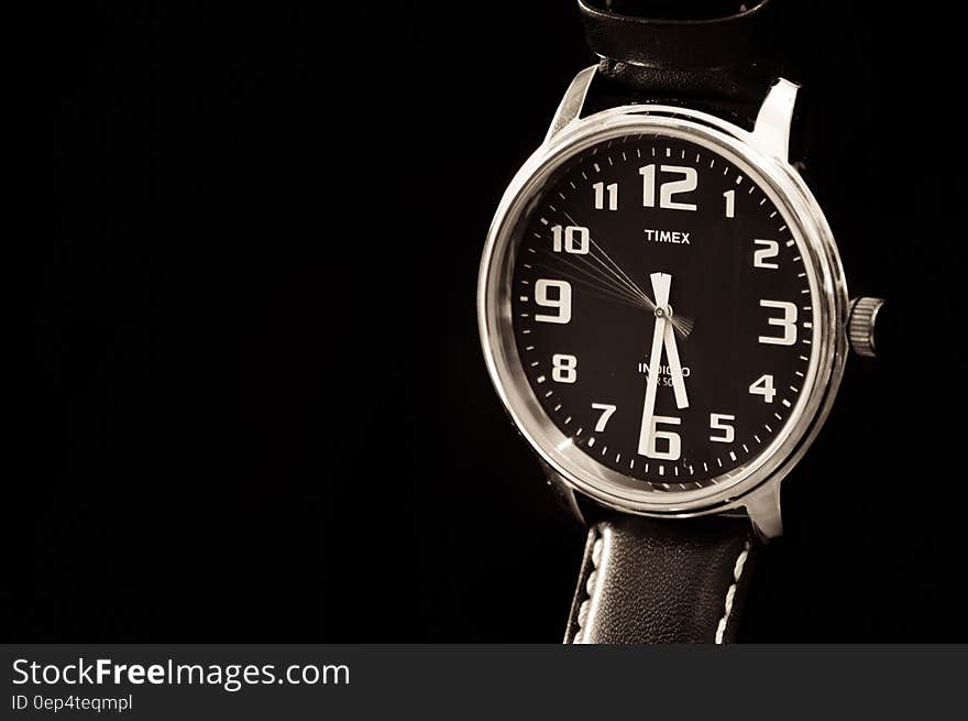 Close up of classic Timex wristwatch with black band and chrome face. Close up of classic Timex wristwatch with black band and chrome face.