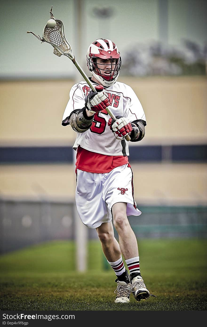 Person Holding Lacrosse Stick during Daytime