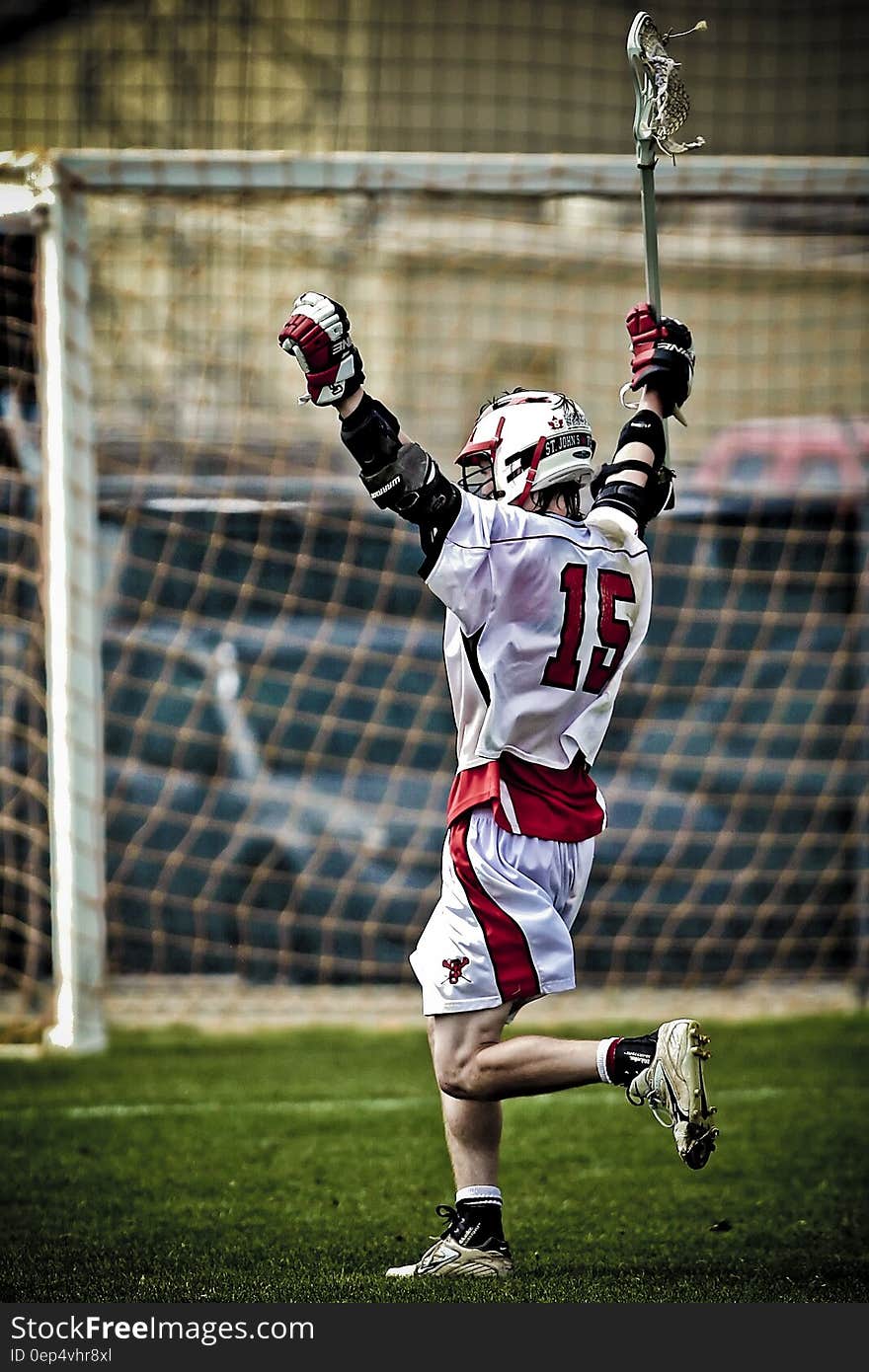 Man Holding Lacrosse Running Towards Goal