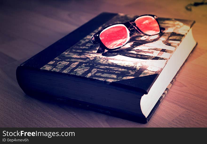 Black Framed Sunglasses on Black Book